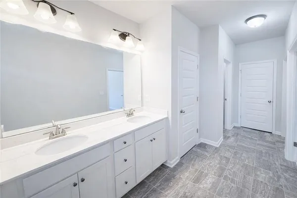a bathroom with a double vanity sink and mirror