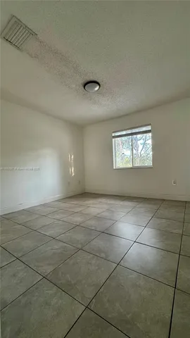 a view of an empty room and a window