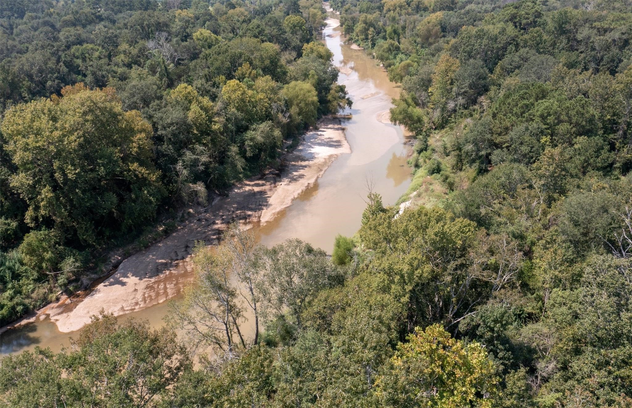a view of a lake with trees all around