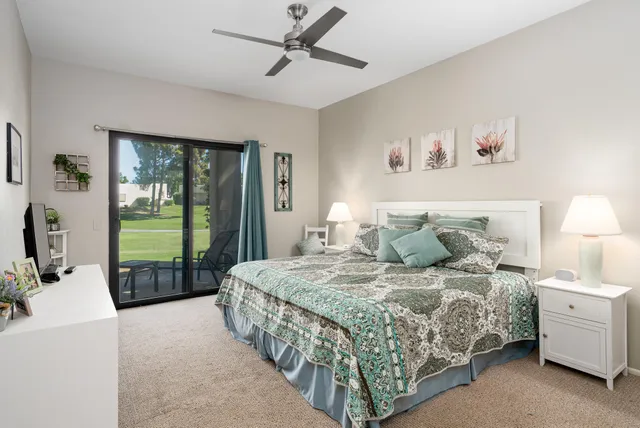 a bedroom with a large bed and a chandelier