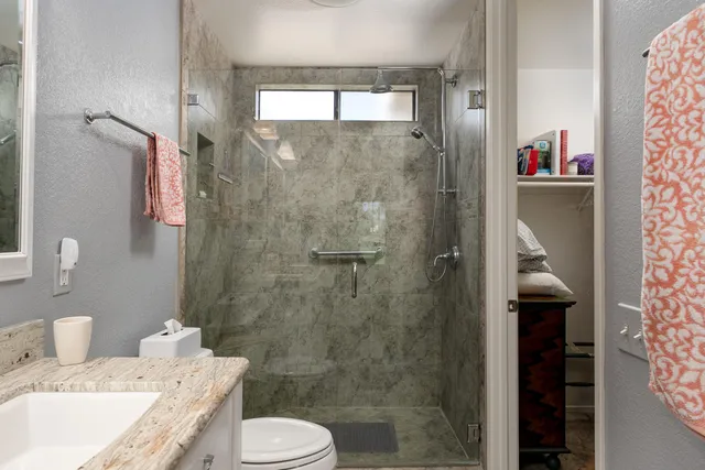 a bathroom with a sink toilet and shower