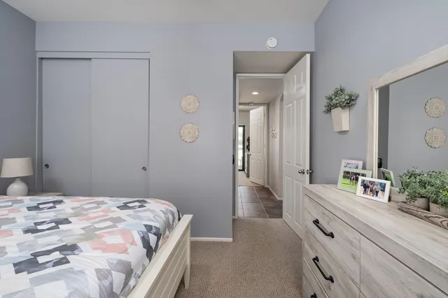 a bedroom with a bed and a mirror