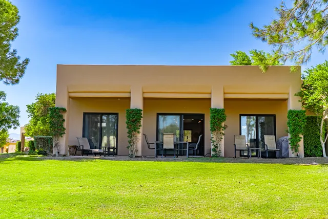 a view of house with swimming pool outdoor seating