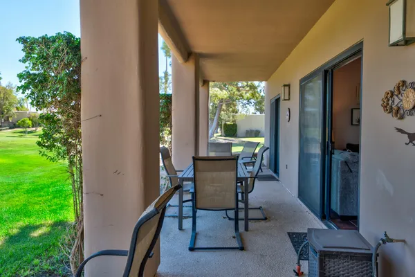a view of a porch with chairs and backyard
