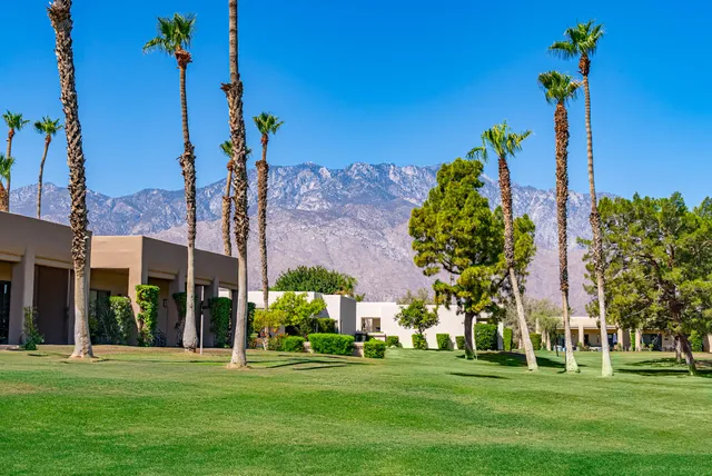 a front view of a building with a garden