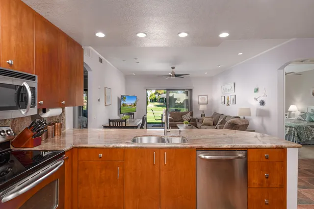 a kitchen with stainless steel appliances granite countertop a sink and stove