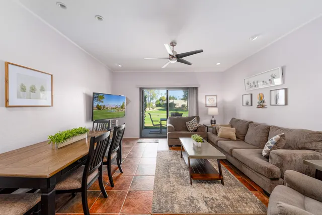 a living room with furniture a chandelier and a table