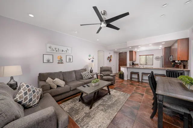 a living room with furniture and kitchen view