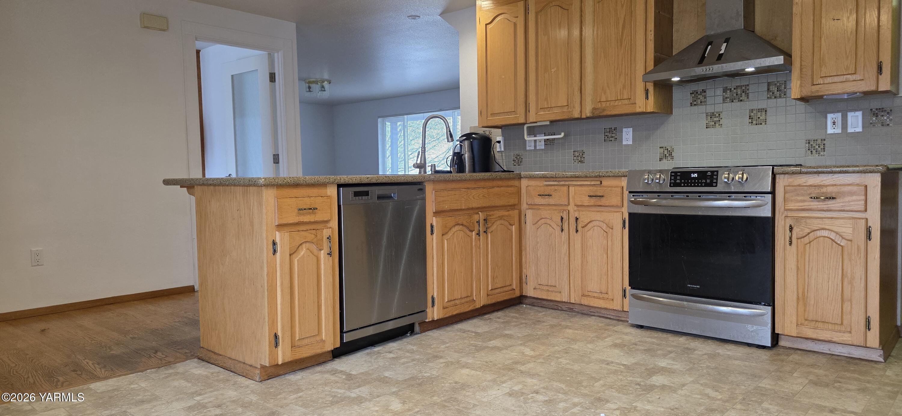 8601 Scenic Drive Yakima, WA 98908 - Photo 6 of 52 a kitchen with stainless steel appliances granite countertop a stove a sink and a refrigerator