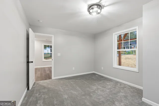 an empty room with windows and entrance