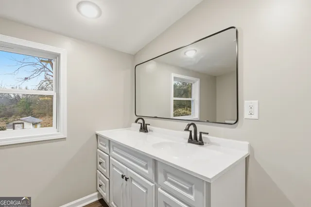 a bathroom with a sink and a mirror