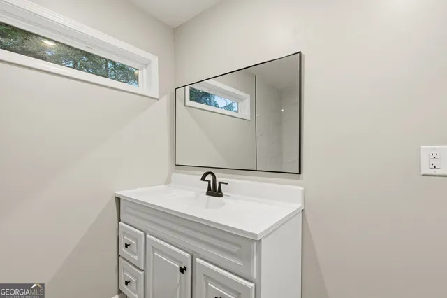 a bathroom with a sink and a mirror