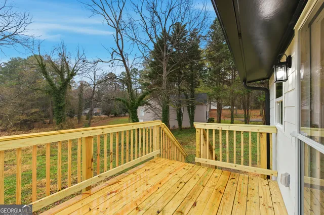 a view of balcony with wooden floor and fence
