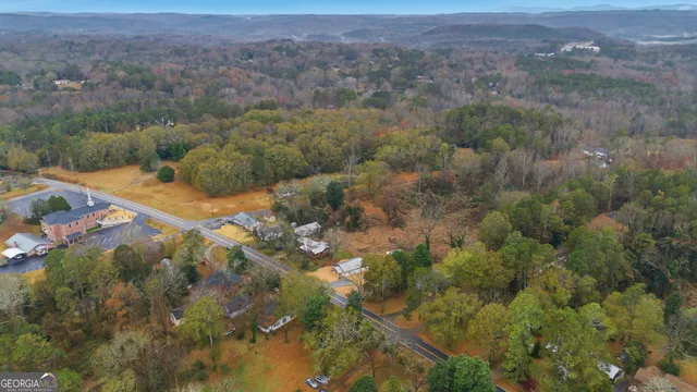 a view of a dry yard with green space and fog