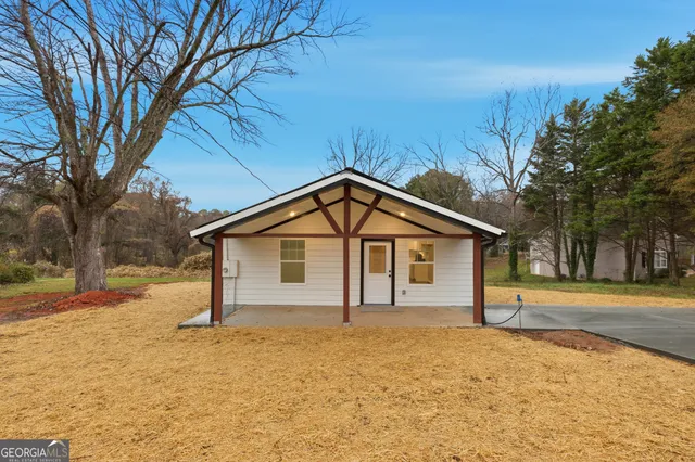 a view of a house with a yard covered in snow