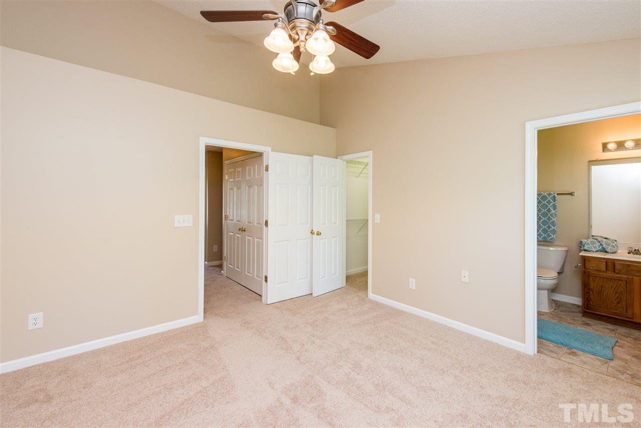 106 Eldon Lane Apex, NC 27502 - Photo 14 of 22 an empty room with closet and a chandelier fan