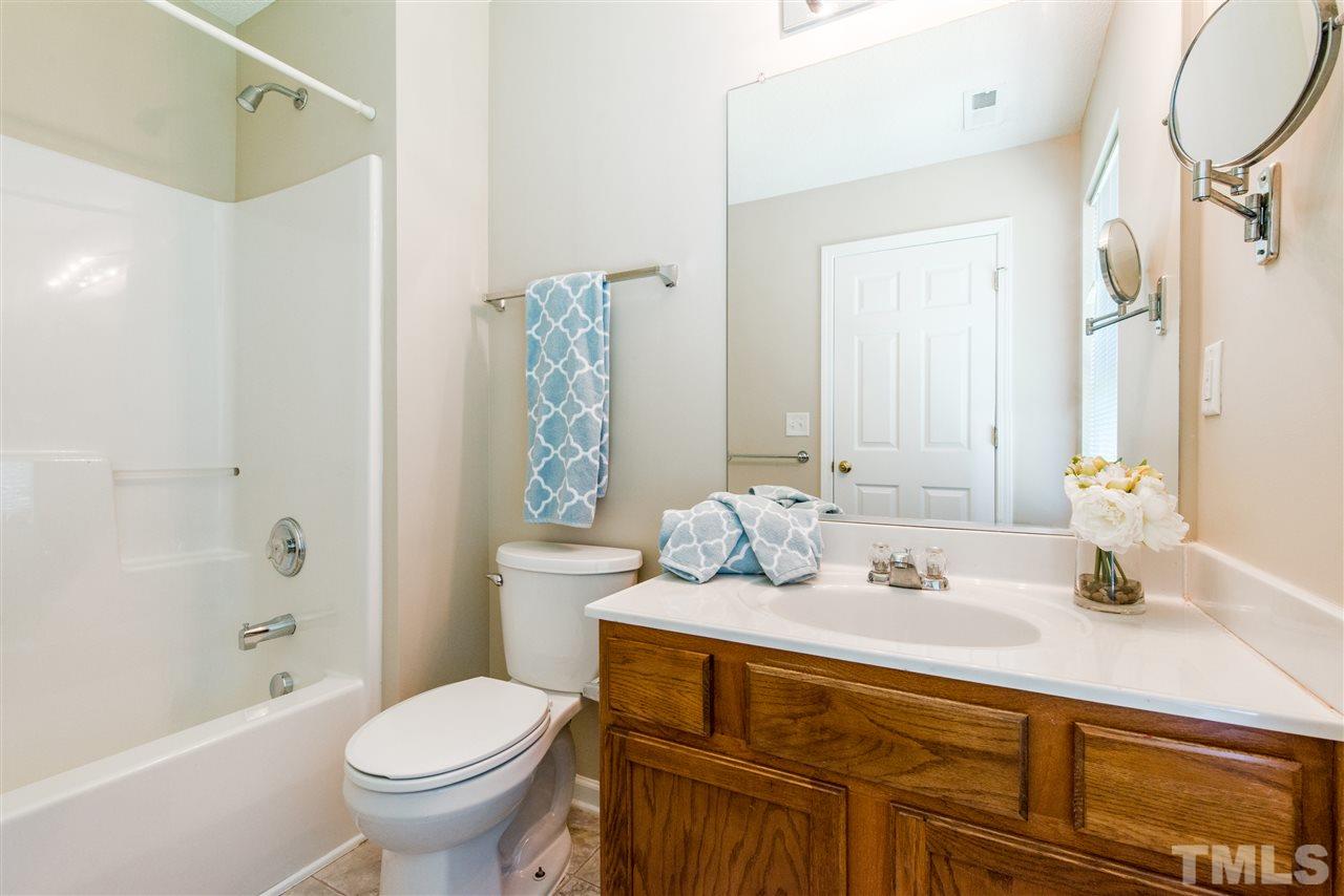 106 Eldon Lane Apex, NC 27502 - Photo 15 of 22 a bathroom with a sink toilet and shower