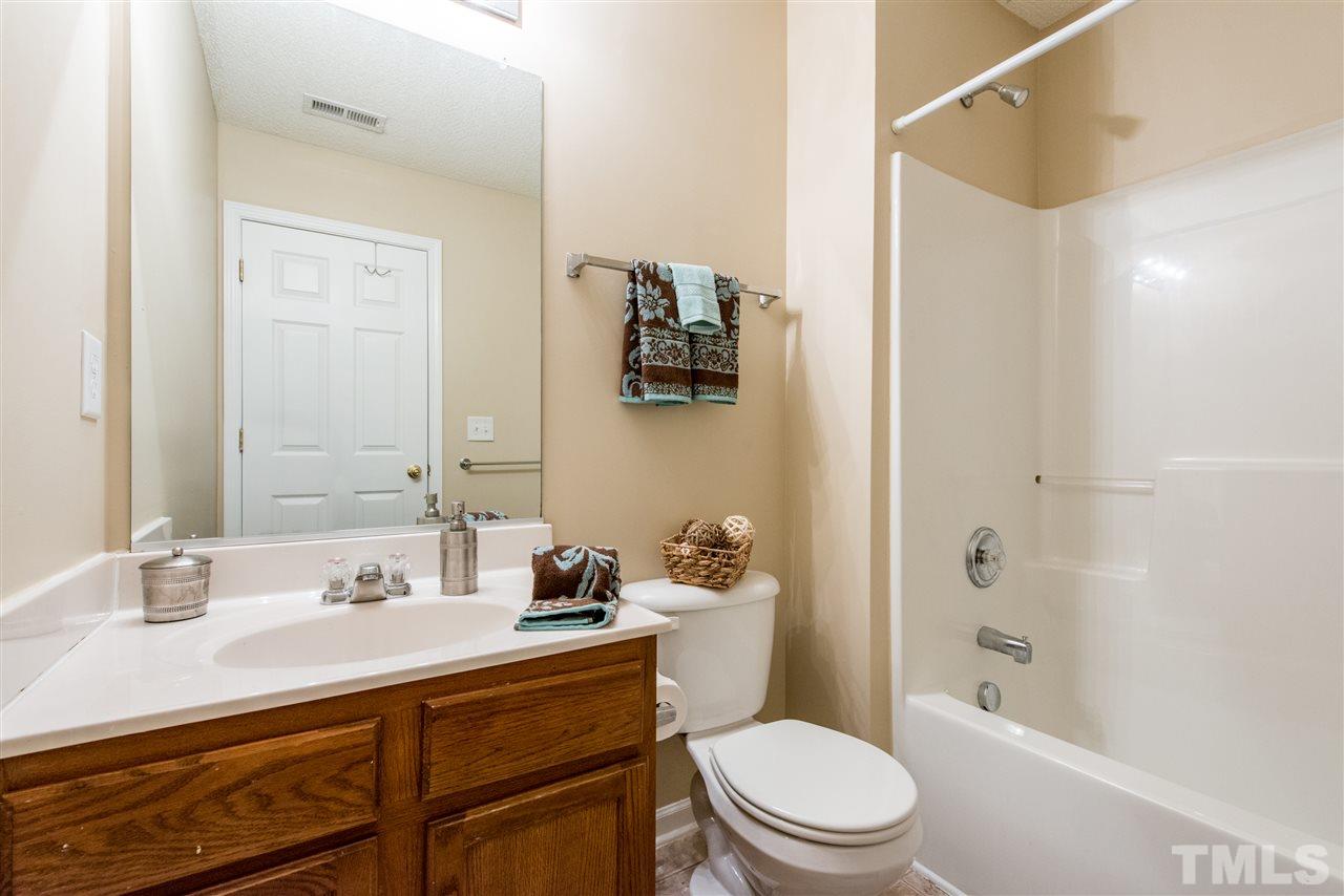 106 Eldon Lane Apex, NC 27502 - Photo 18 of 22 a bathroom with a sink a toilet and shower