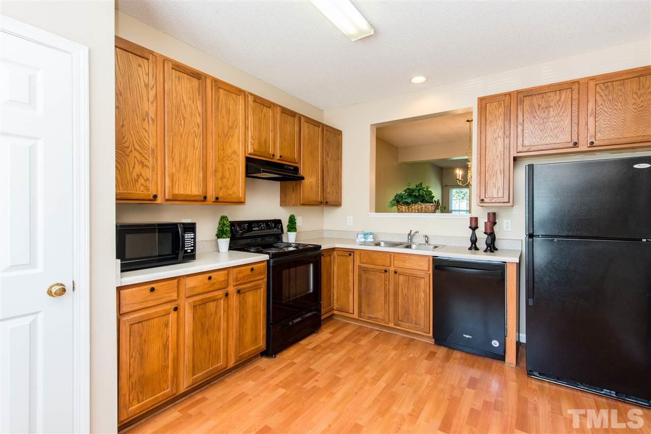 106 Eldon Lane Apex, NC 27502 - Photo 4 of 22 a kitchen with a sink stove and refrigerator