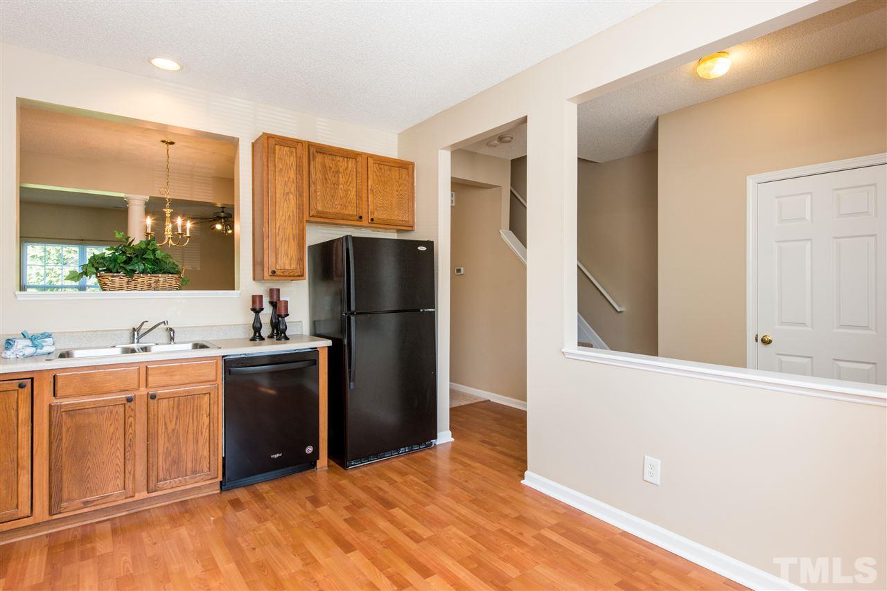 106 Eldon Lane Apex, NC 27502 - Photo 5 of 22 a kitchen with granite countertop a refrigerator and a sink