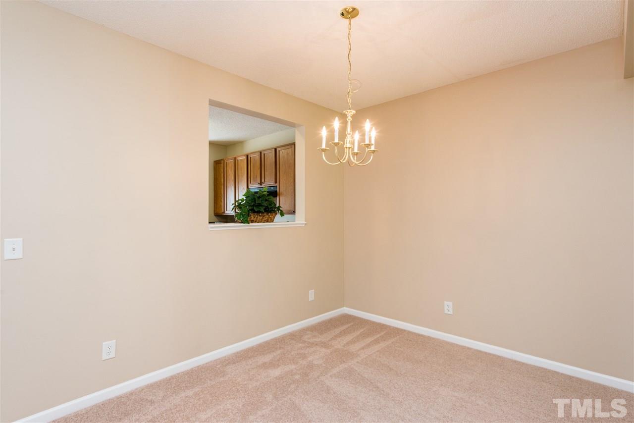 106 Eldon Lane Apex, NC 27502 - Photo 7 of 22 en empty room with a chandelier fan