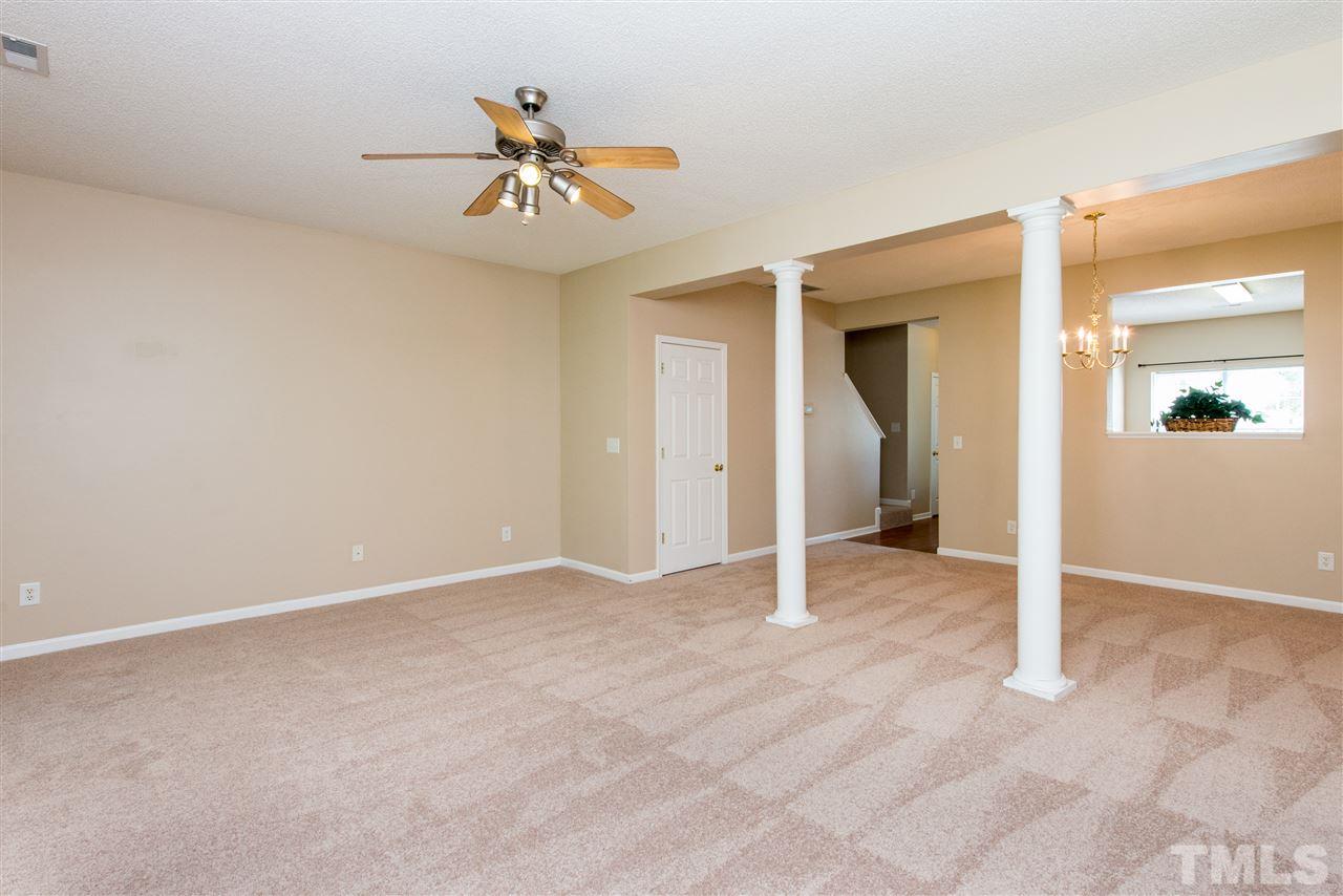 106 Eldon Lane Apex, NC 27502 - Photo 10 of 22 an empty room and chandelier fan