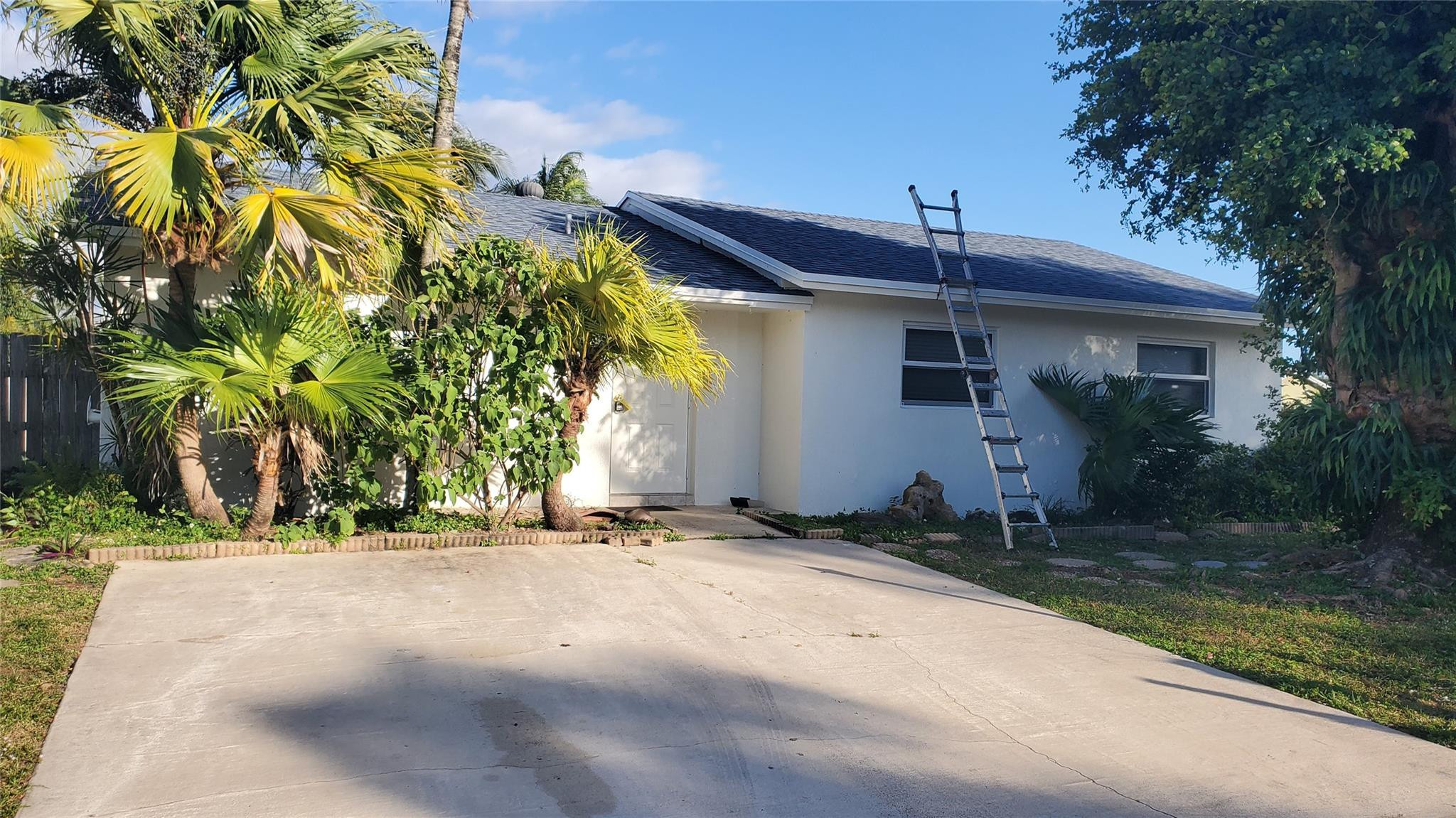 10734 Shady Pond Lane Boca Raton, FL 33428 - Photo 1 of 23 a backyard of a house with plants and trees