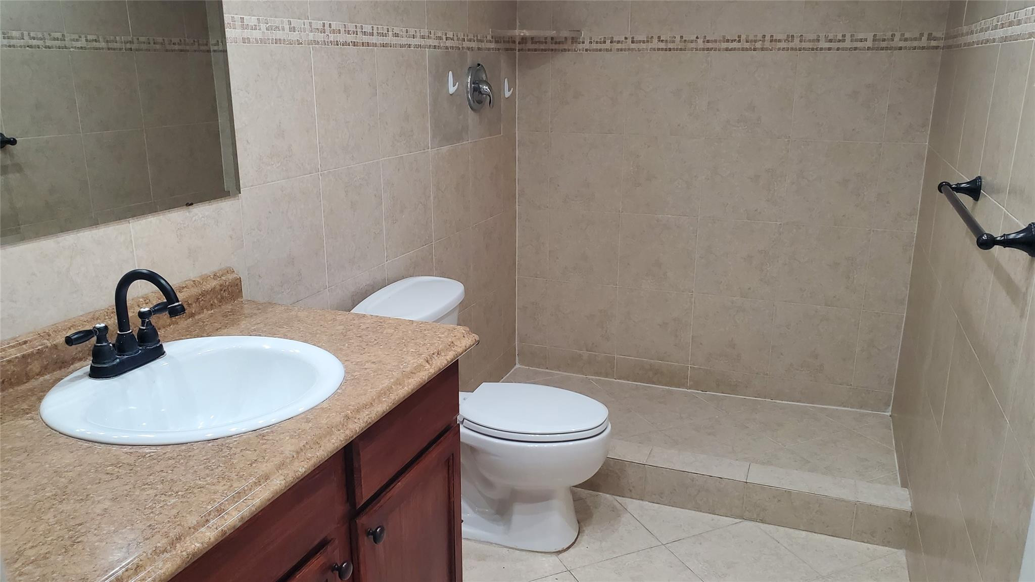 10734 Shady Pond Lane Boca Raton, FL 33428 - Photo 15 of 23 a bathroom with a granite countertop sink toilet and a shower