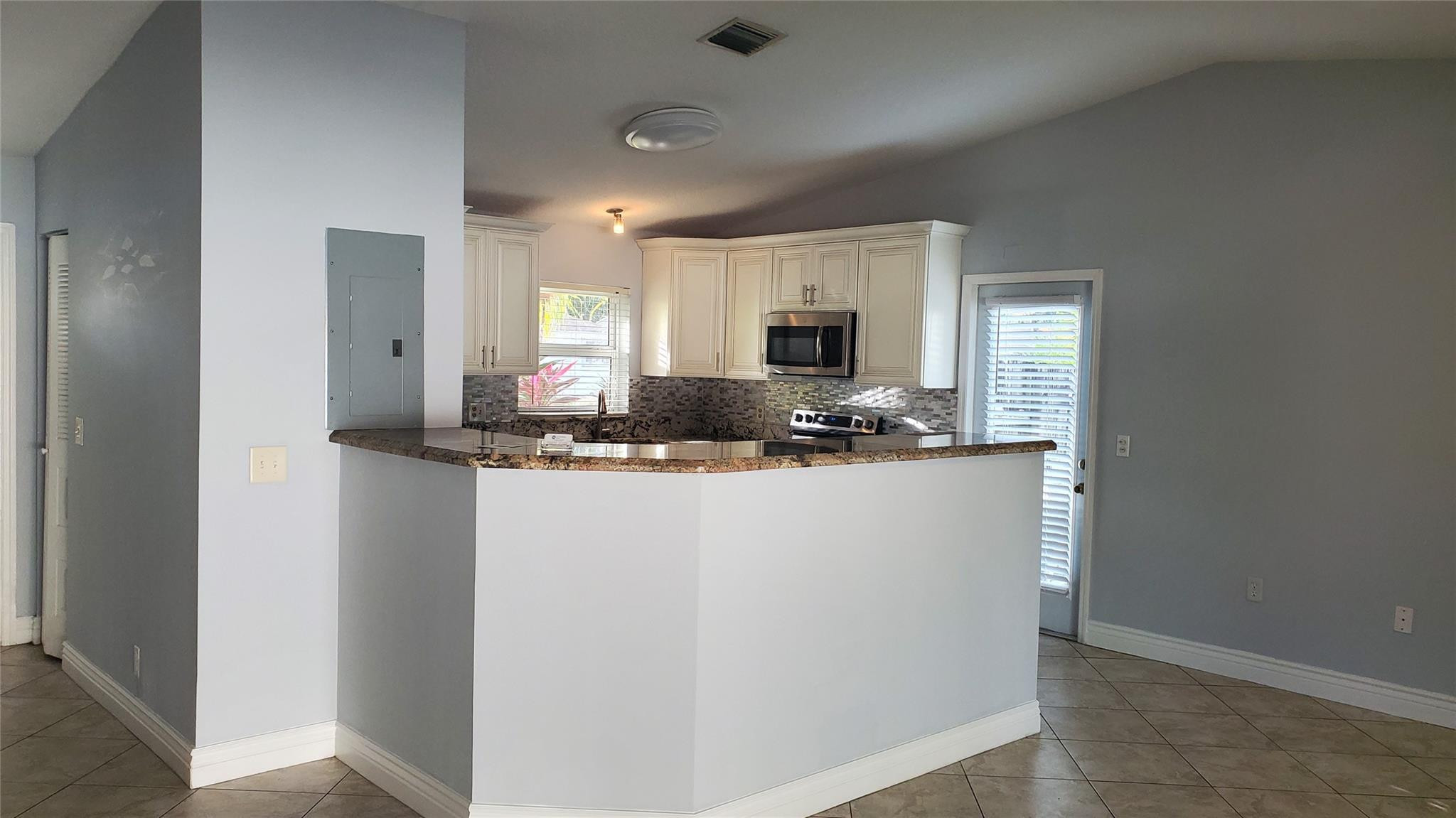 10734 Shady Pond Lane Boca Raton, FL 33428 - Photo 4 of 23 a kitchen with kitchen island a counter top space and cabinets