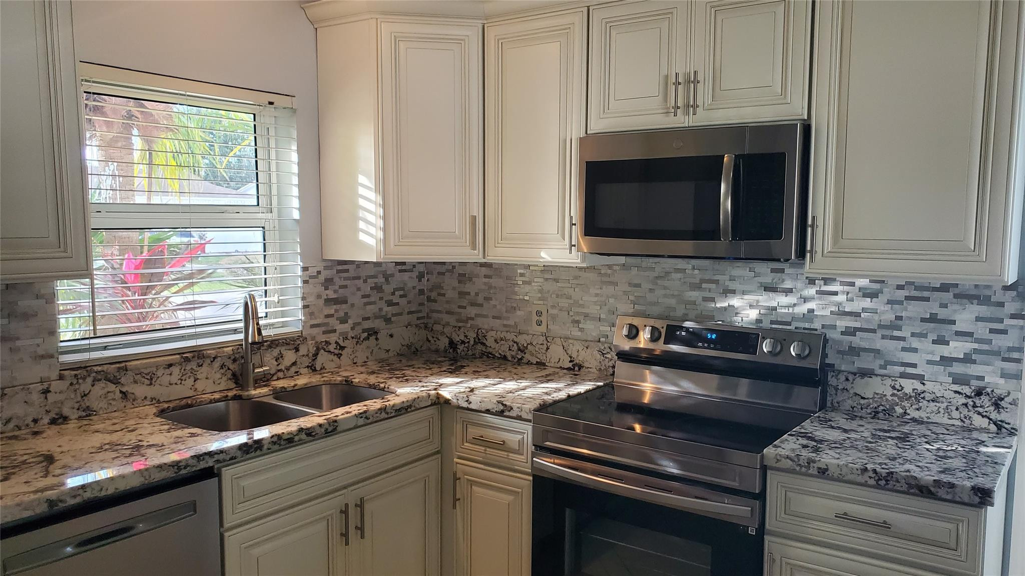 10734 Shady Pond Lane Boca Raton, FL 33428 - Photo 6 of 23 a kitchen with a sink stove and microwave