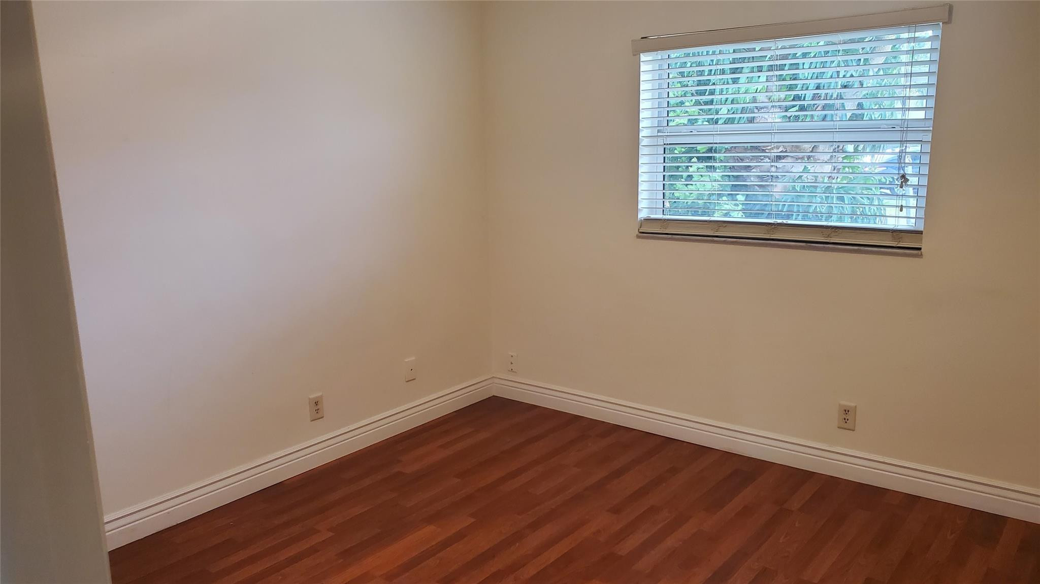 10734 Shady Pond Lane Boca Raton, FL 33428 - Photo 8 of 23 an empty room with wooden floor and windows