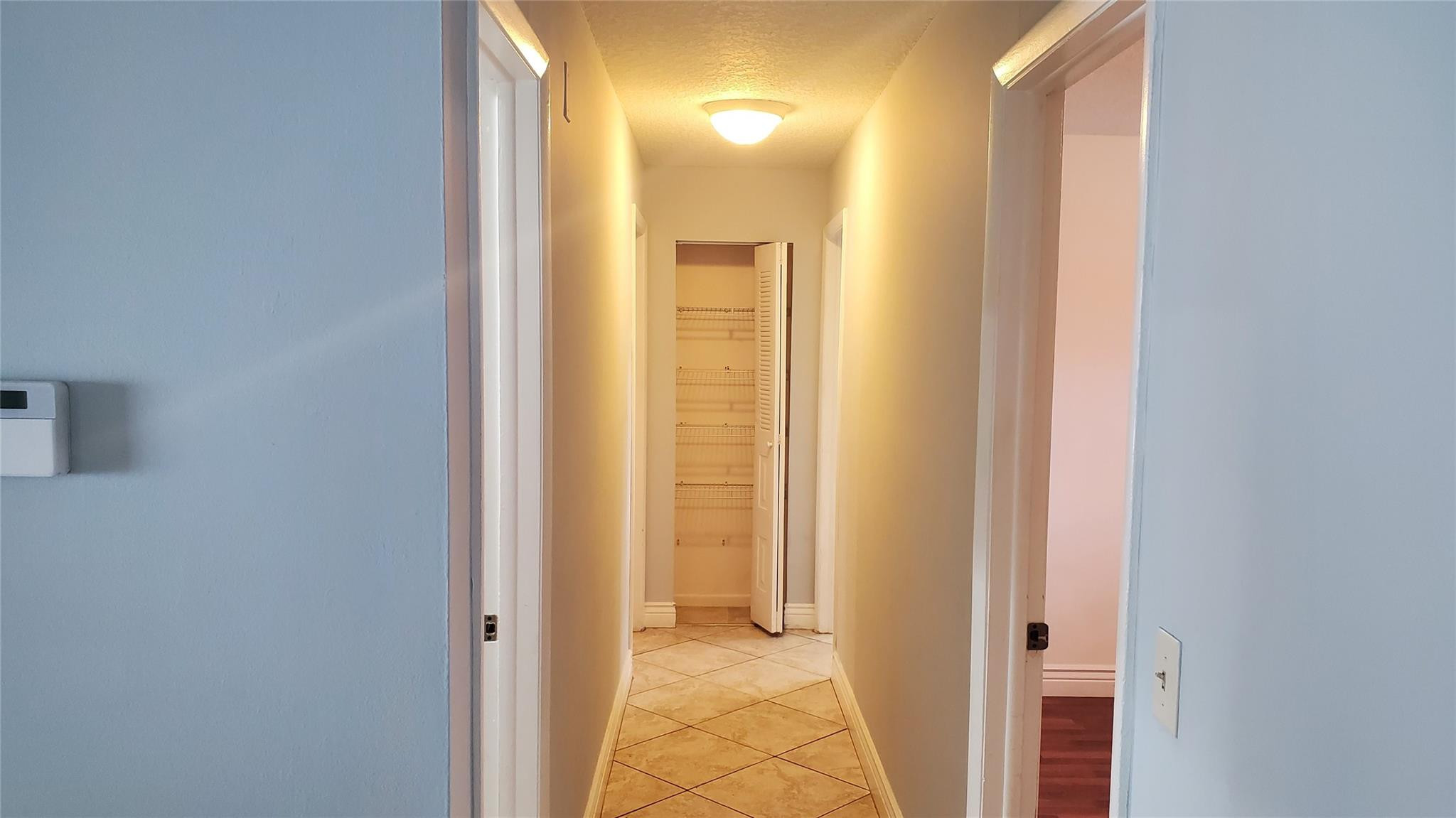 10734 Shady Pond Lane Boca Raton, FL 33428 - Photo 10 of 23 a view of a bathroom from a corridor