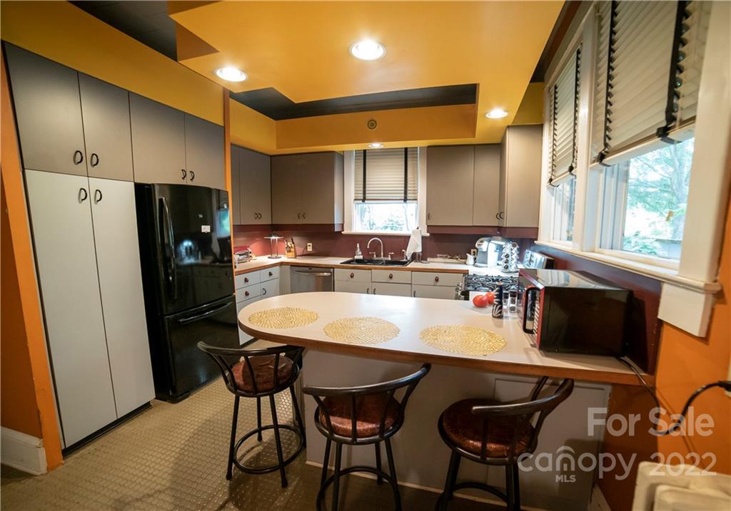 100 Morehead Street Morganton, NC 28655 - Photo 17 of 37 a kitchen with stainless steel appliances a dining table and chairs