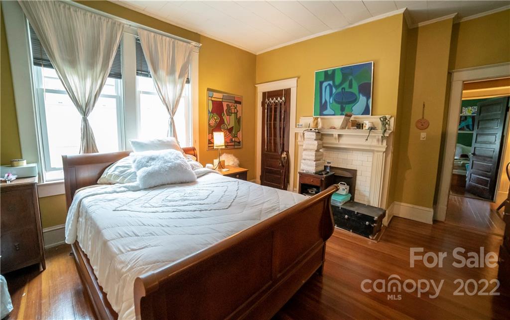 100 Morehead Street Morganton, NC 28655 - Photo 25 of 37 a bedroom with a bed next to a window with kitchen view