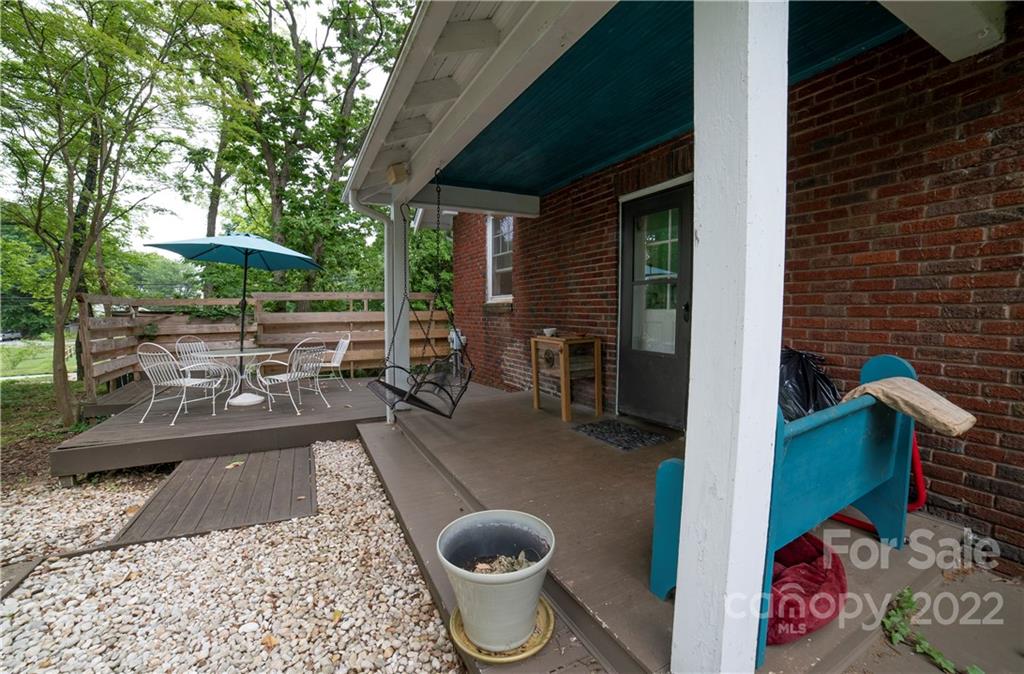 100 Morehead Street Morganton, NC 28655 - Photo 33 of 37 a view of a patio with table and chairs potted plants and a large tree