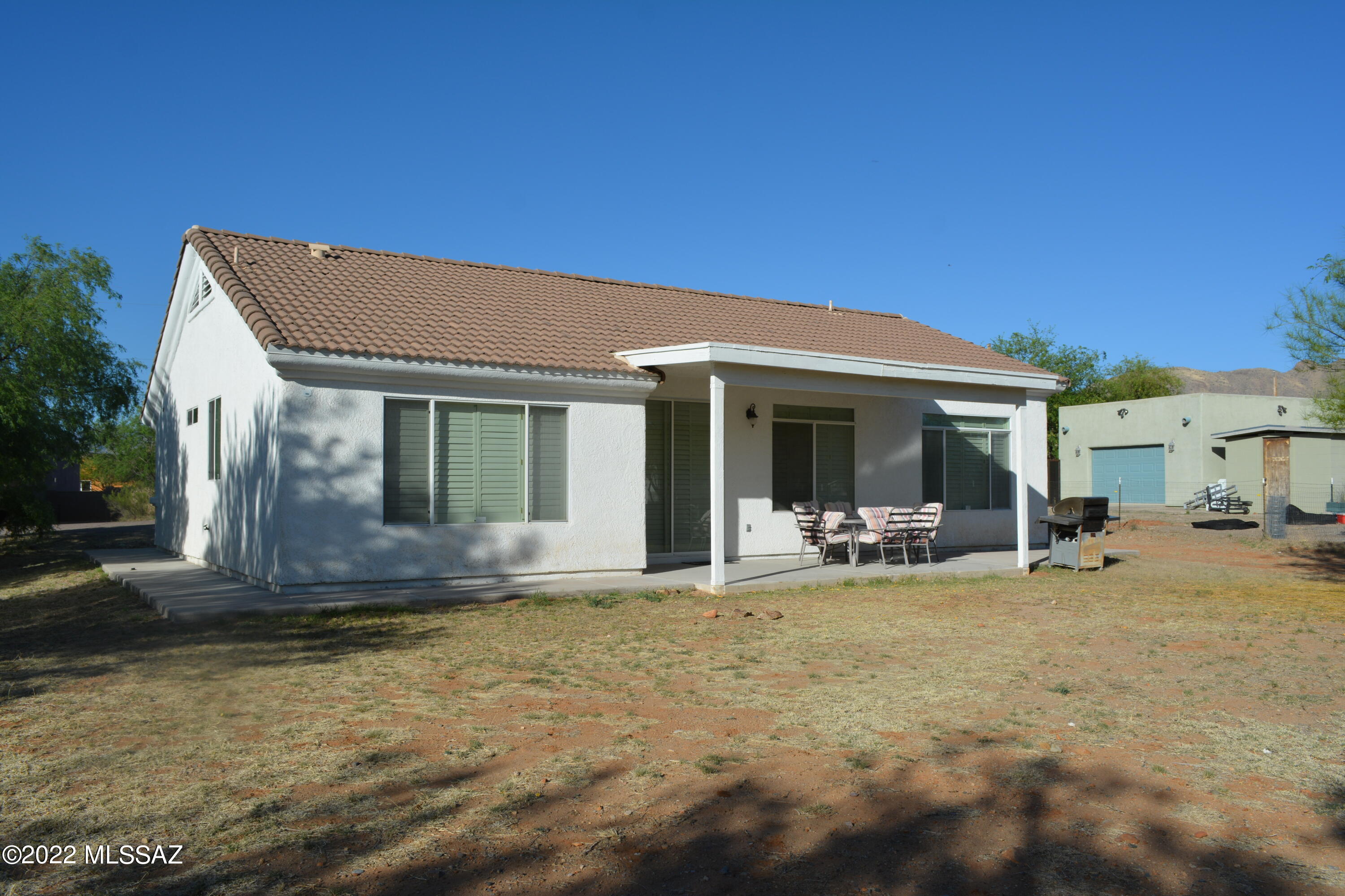 1714 Camino Rivera Rio Rico, AZ 85648 - Photo 24 of 26 a view of a house with backyard porch and sitting area
