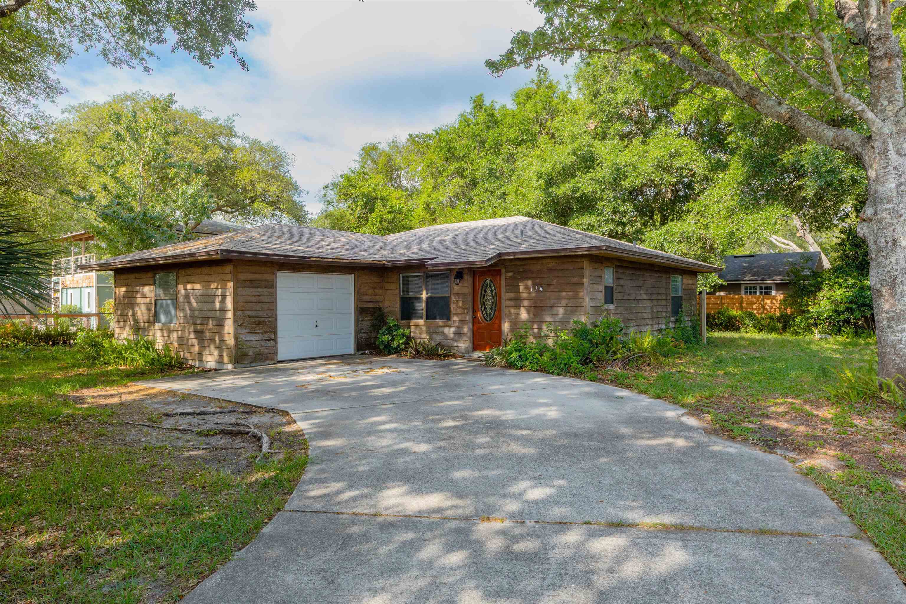 a front view of a house with a garden