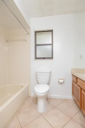 a bathroom with a toilet and a bathtub