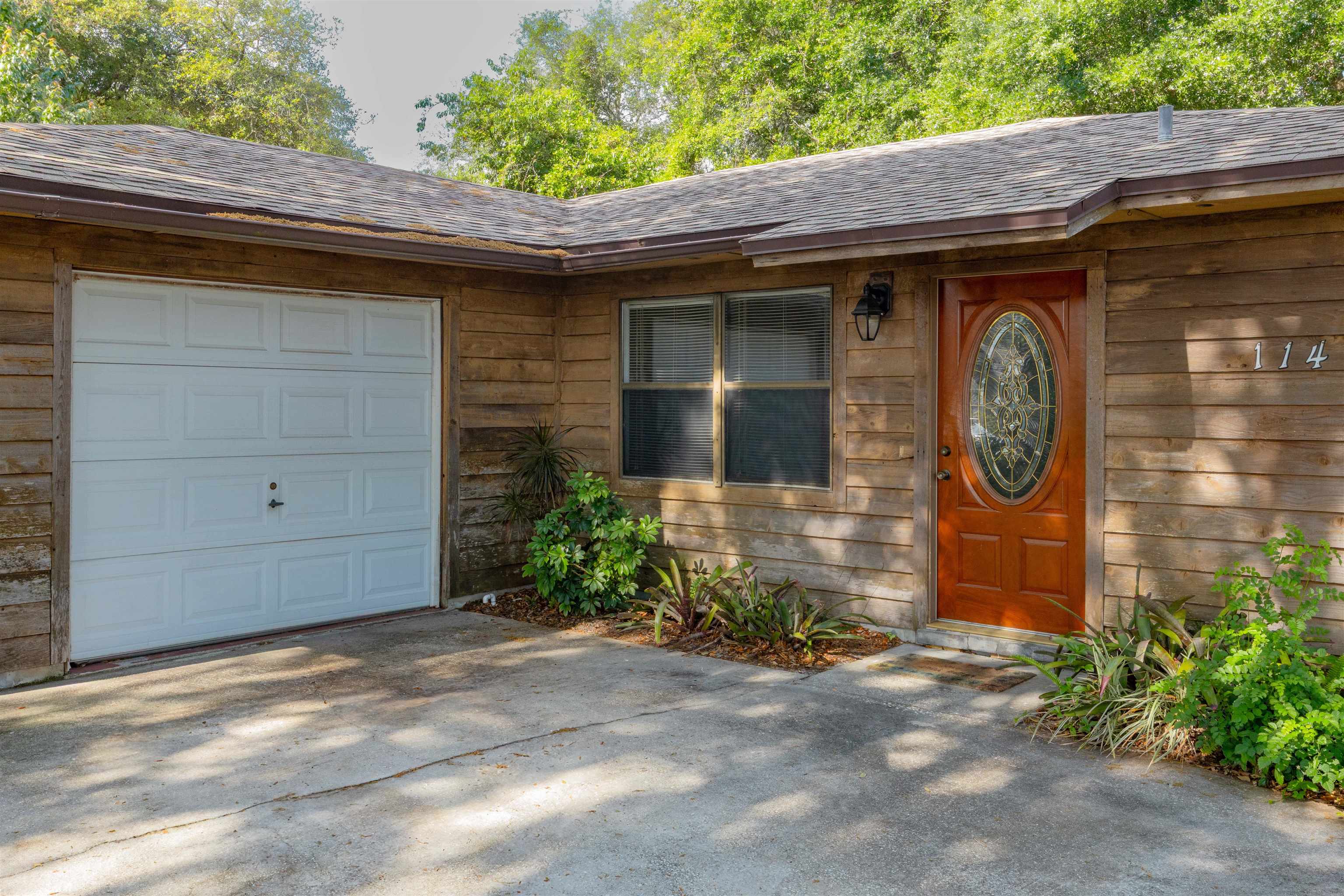 114 Lobelia Road St. Augustine, FL 32086 - Photo 3 of 38 a front view of a house with garden