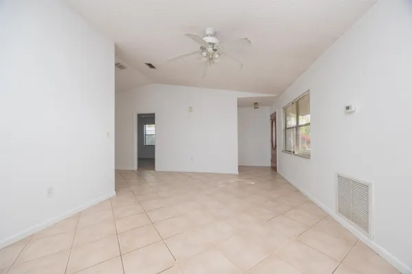 a view of an empty room with a ceiling fan