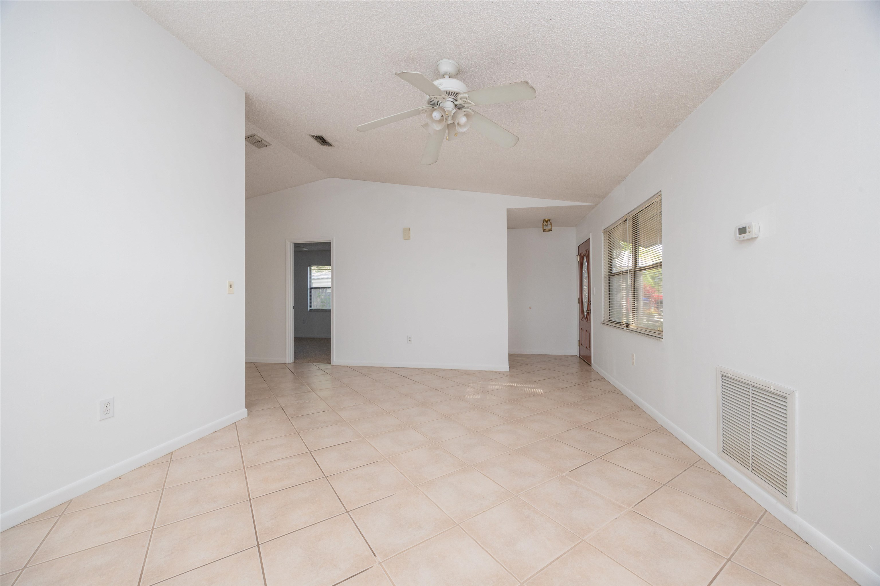 114 Lobelia Road St. Augustine, FL 32086 - Photo 6 of 38 a view of an empty room with a ceiling fan
