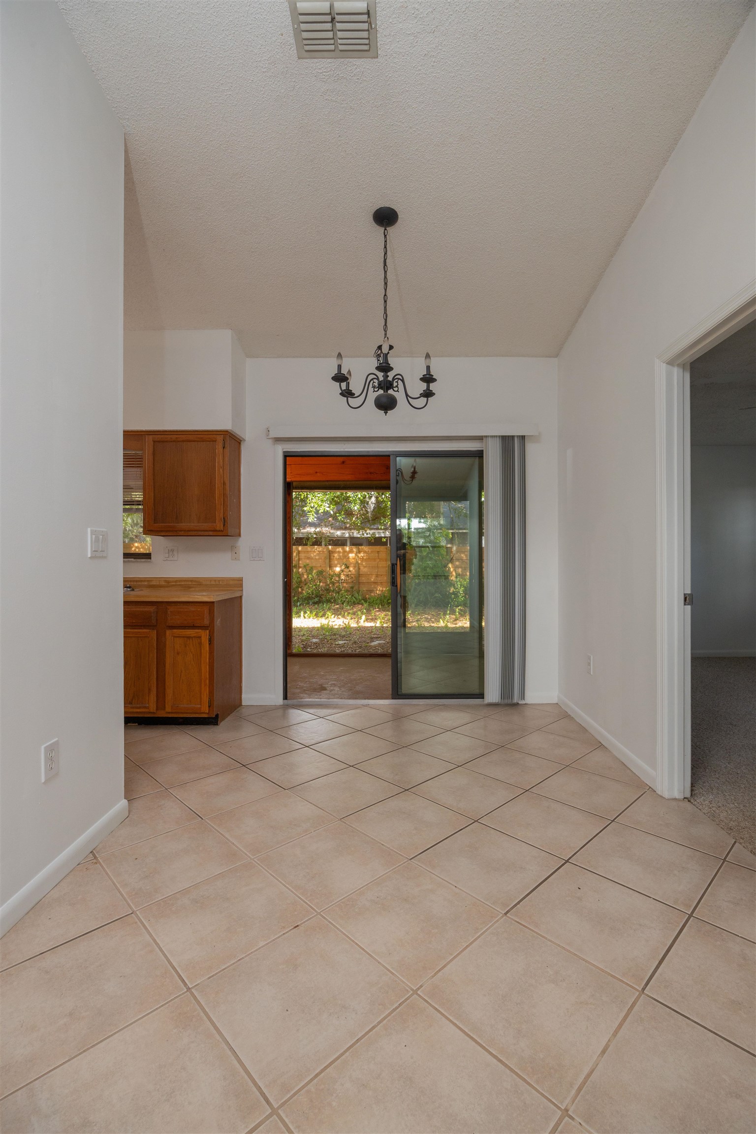 114 Lobelia Road St. Augustine, FL 32086 - Photo 7 of 38 a view of an empty room with a window and kitchen view