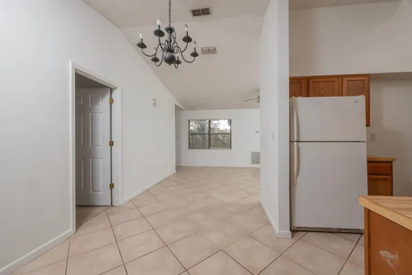a view of a hallway with a refrigerator