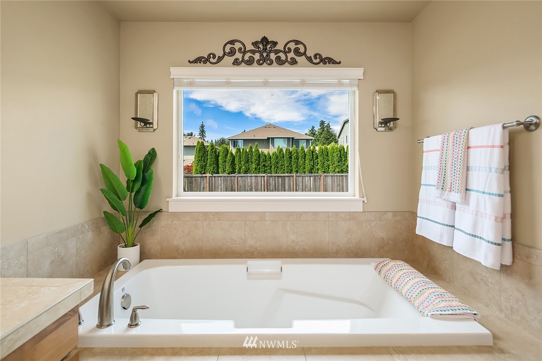 6308 Southeast 2nd Street Renton, WA 98059 - Photo 18 of 29 a bath tub sitting in a bathroom next to a window