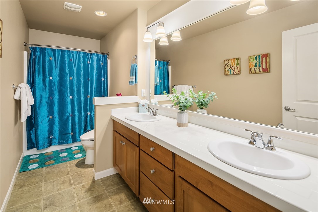 6308 Southeast 2nd Street Renton, WA 98059 - Photo 22 of 29 a bathroom with a double vanity sink mirror and