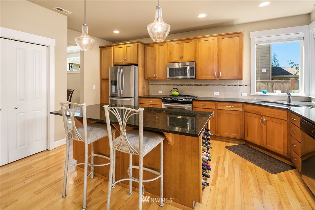 6308 Southeast 2nd Street Renton, WA 98059 - Photo 8 of 29 a kitchen with stainless steel appliances a sink stove and refrigerator