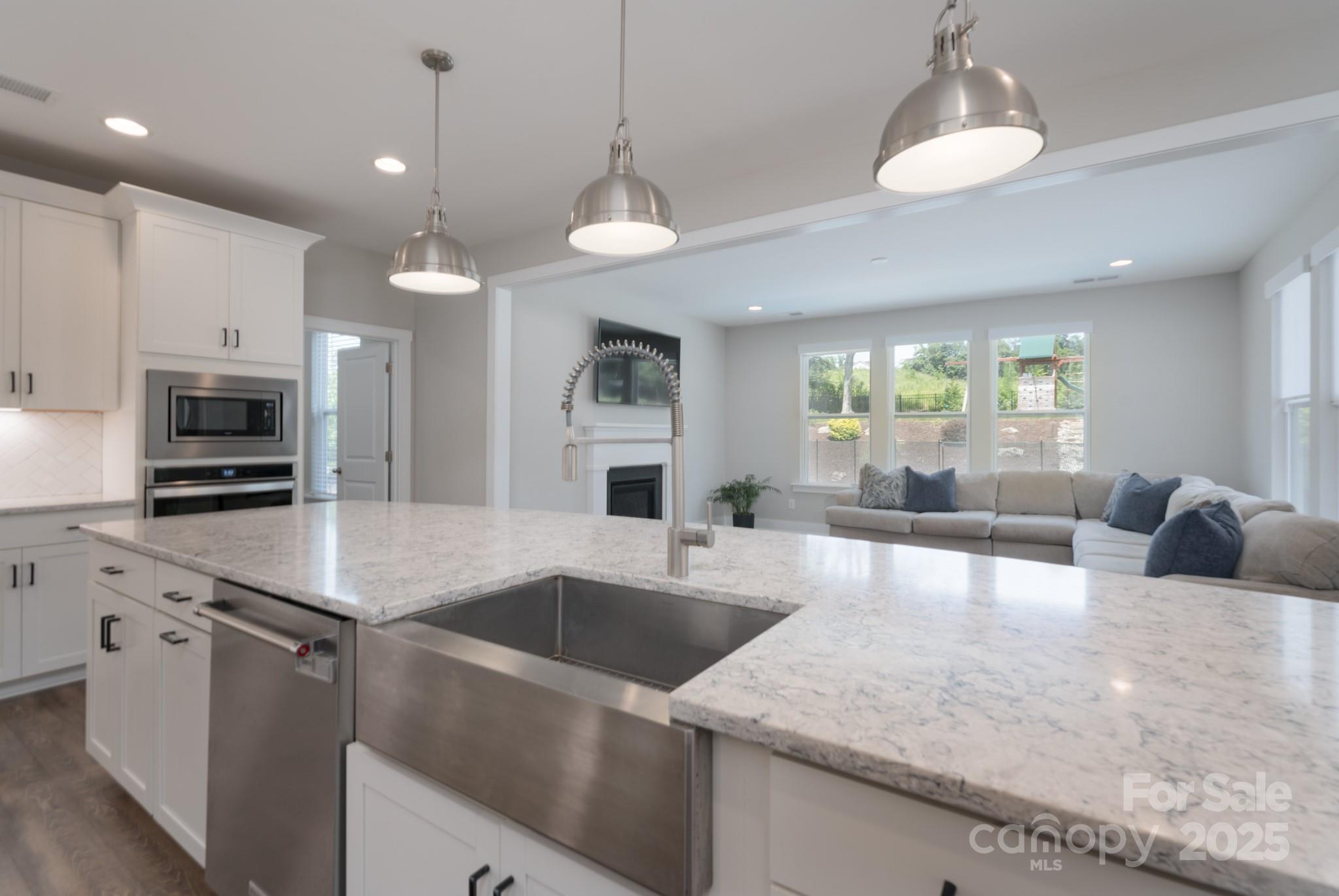 1180 Weir Court Fort Mill, SC 29708 - Photo 13 of 37 a kitchen with granite countertop a sink a counter top space appliances and cabinets