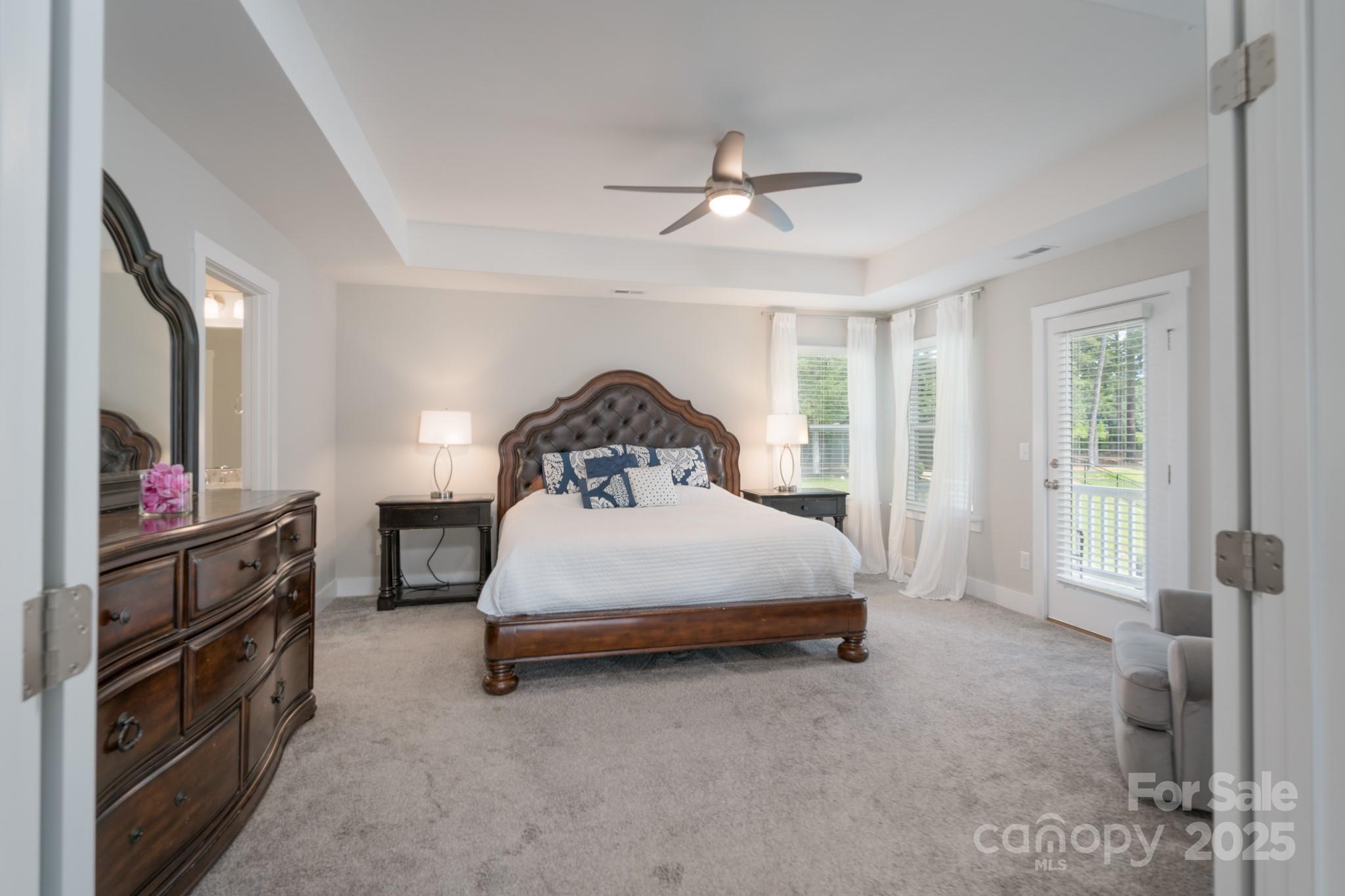1180 Weir Court Fort Mill, SC 29708 - Photo 22 of 37 a bedroom with a bed next to a window with a flat screen tv