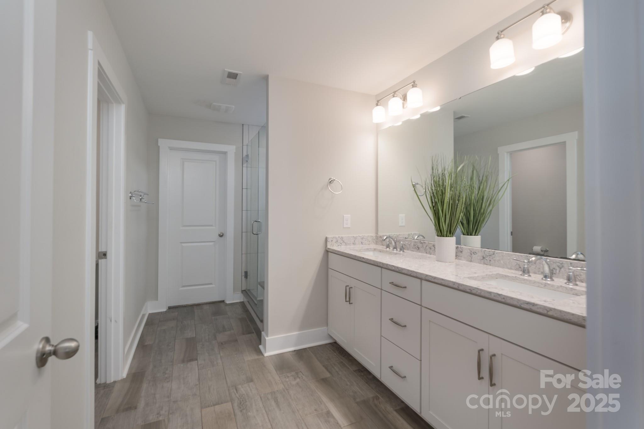 1180 Weir Court Fort Mill, SC 29708 - Photo 24 of 37 a spacious bathroom with a double vanity sink and mirror