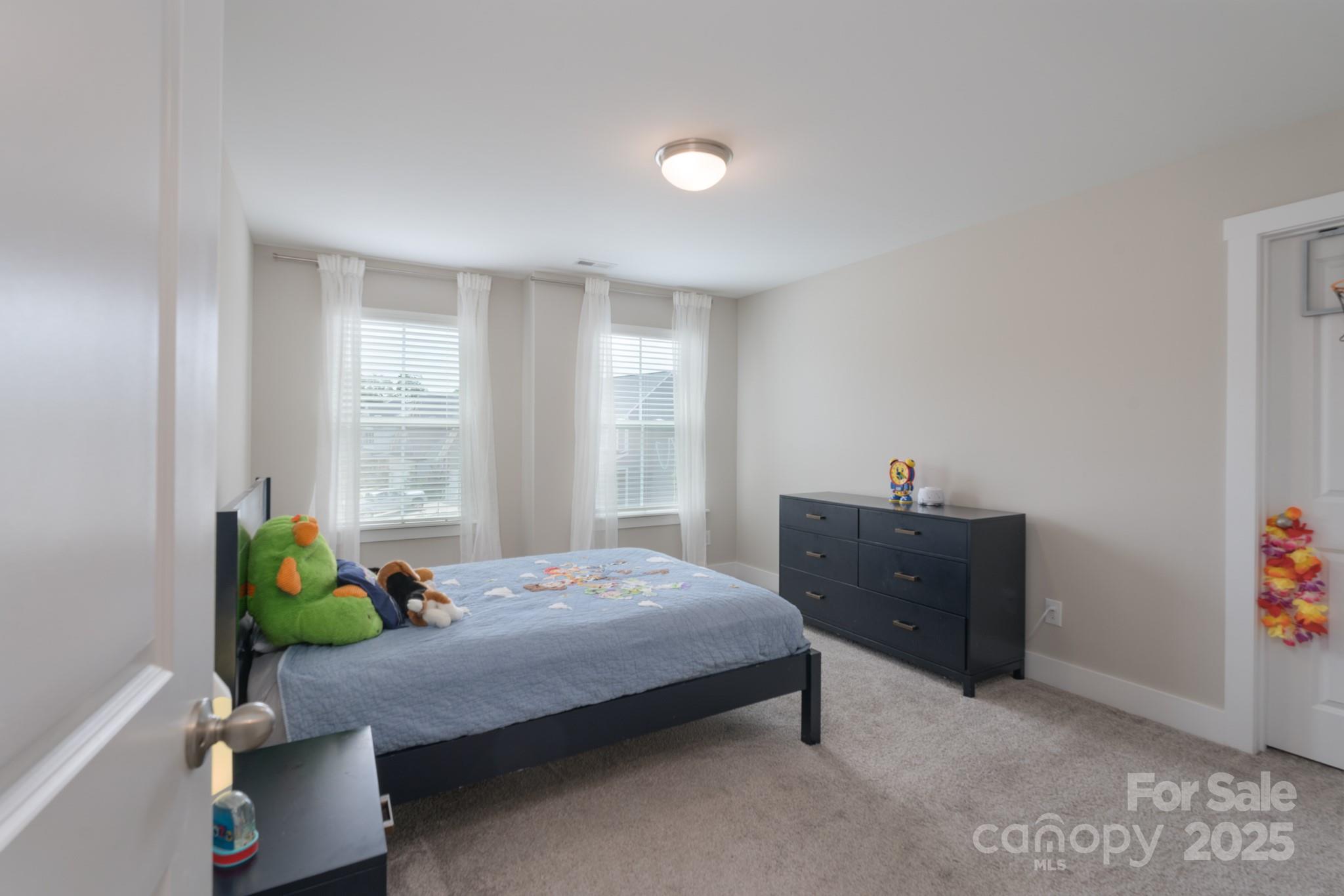 1180 Weir Court Fort Mill, SC 29708 - Photo 25 of 37 a bedroom with a bed and a dresser